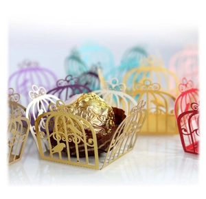 Golden laser-cut birdcage candy box with intricate floral patterns for weddings