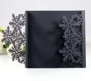 Detailed laser-cut black snowflake invitation card featuring an elegant tri-fold design