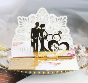 Detailed laser-cut gold mirror wedding card featuring Mr & Mrs heart and ring designs