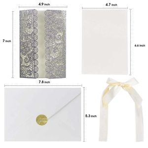 Close-up of laser-cut lace invitation set with glitter finish and satin ribbon bow