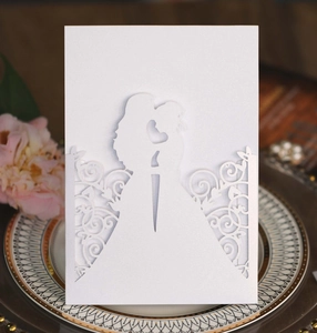 Detailed macro shot of white laser-cut invitation card with floral patterns