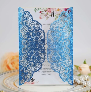 Detail of laser-cut lace wedding invitation in glitter blue with elegant floral insert