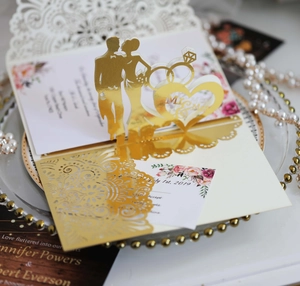 Detail of laser cut wedding invitation with pop-up Mr & Mrs design and floral card