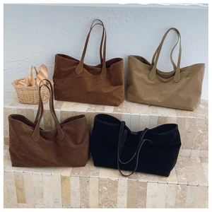 Collection of minimalist suede tote bags in dark brown, black, and tan earth tones