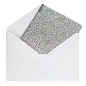 Detailed view of silver glitter lace laser-cut wedding invitation with white envelope