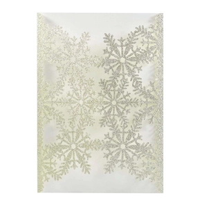 Macro detail of laser-cut white snowflake invitation with shimmering silver glitter finish