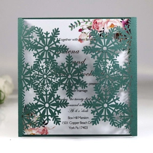 Detailed laser-cut snowflake wedding invitation with white floral inner sheet