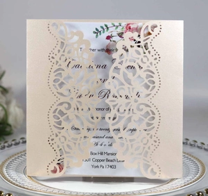 Detailed laser-cut champagne gold wedding invitation card with intricate mandala floral patterns