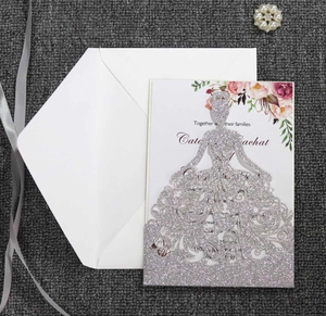 Detail of laser cut silver glitter princess dress invitation with floral inner card