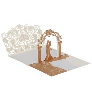 Detail of 3D laser cut wedding card featuring rose gold glitter and couple silhouette