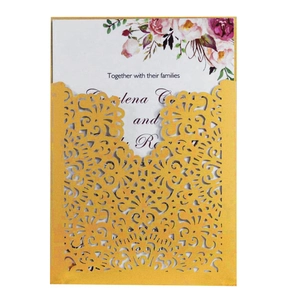 Detail of laser-cut floral wedding invitation with pink flower printed insert card