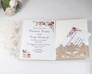 Detailed laser-cut silver snowflake wedding invitation set with floral inner cards