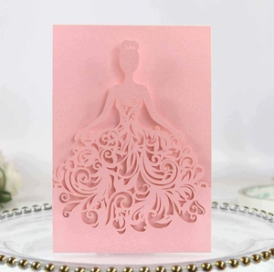 Detail of pink laser-cut wedding invitation featuring elegant female silhouette and floral patterns