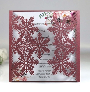 Detailed laser-cut snowflake wedding invitation with burgundy cover and floral inner card