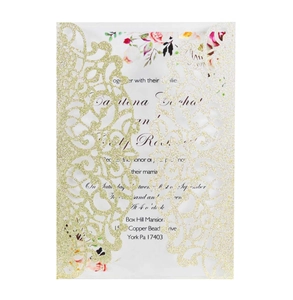 Detail of laser-cut glitter cardstock invitation with intricate mandala floral patterns