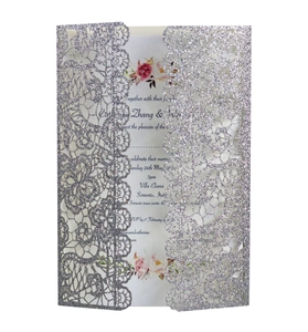 Detailed laser-cut silver glitter wedding invitation with elegant lace floral hollow design