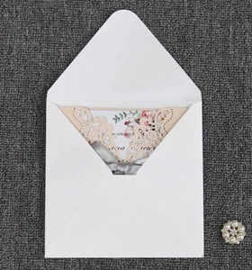 Detailed laser-cut wedding invitation with beige floral patterns and gray silk ribbon bow