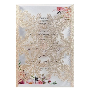 Detailed laser-cut snowflake invitation with gold glitter and floral inner card