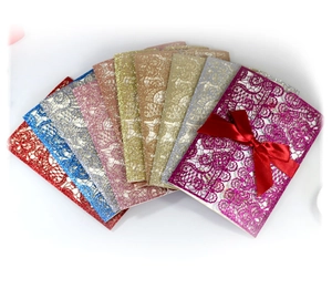 Laser-cut glitter hollow invitation cards with ribbons in various vibrant colors