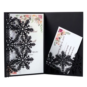 Detailed laser cut snowflake invitation cover with elegant floral insert cards