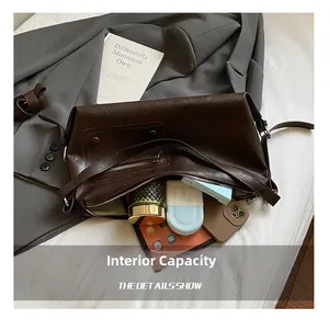Macro view of interior storage capacity in the vintage dark brown faux leather shoulder bag