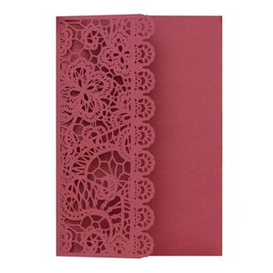 Macro detail of laser-cut burgundy lace wedding invitation with floral hollow pattern