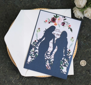 Laser-cut wedding invitation featuring two brides silhouette and elegant floral inner card