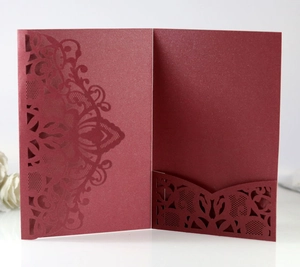 Détail d'une invitation découpée au laser rouge foncé avec motifs floraux en papier perlé