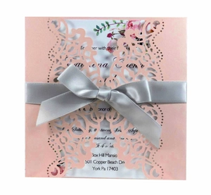 Elegant laser-cut pink wedding invitation with silver grey ribbon and floral pattern