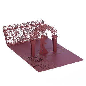 Detail of red 3D pop-up wedding invitation with laser-cut heart and couple silhouette