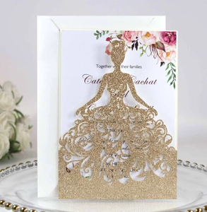 Detail of laser-cut gold glitter wedding invitation with elegant bride silhouette