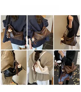 Detail view of stylish tote bags in black, brown, and white with bear charms