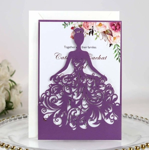 Detail of laser-cut purple silhouette wedding invitation with lace floral patterns