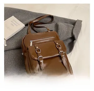 Detailed macro view of vintage brown oiled leather backpack with metal buckles and zippers