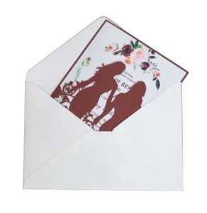 Laser-cut burgundy wedding invitation featuring two brides silhouette and floral inner card