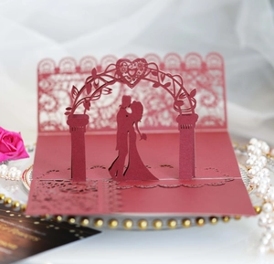 Detailed 3D laser-cut wedding invitation featuring a romantic couple under a floral arch