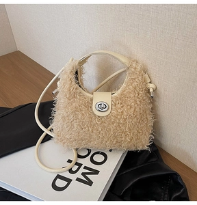 Detail of light beige faux shearling handbag with silver turn-lock and leather flap