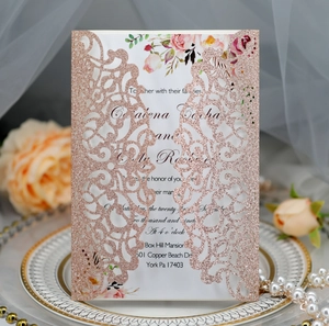 Detailed laser-cut rose gold glitter wedding invitation with elegant floral interior card