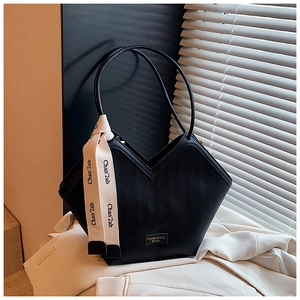 Detail of black woven tote bag featuring a V-shaped opening and decorative silk scarf