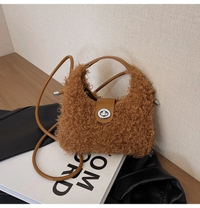 Detailed view of plush faux fur texture and silver metal twist lock on a brown bag