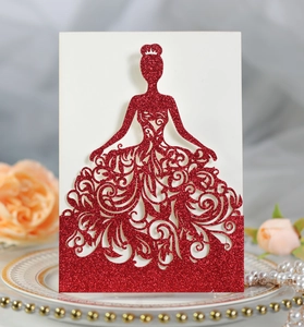 Macro detail of laser-cut red glitter invitation with elegant female silhouette