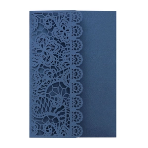 Close-up of dark blue laser-cut lace floral pattern on a premium wedding invitation card
