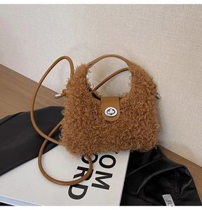 Detail of plush brown faux shearling bag with silver twist lock and leather strap