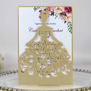 Macro detail of laser-cut bridal silhouette on a gold wedding invitation sleeve