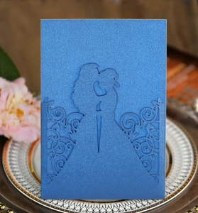 Laser-cut royal blue wedding invitation featuring a silhouette of a romantic couple kissing