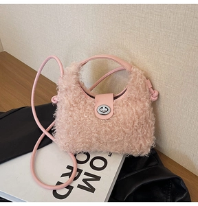 Detail of pink faux shearling handbag with silver metal twist lock and leather strap