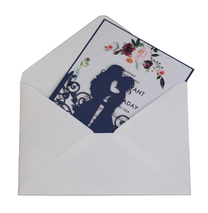 Navy blue laser-cut wedding invitation featuring bride and groom silhouette and floral inner card