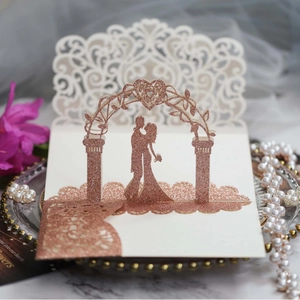 Elegant 3D laser-cut wedding invitation with rose gold glitter and floral lace pattern