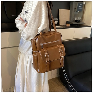 Detail view of the retro caramel oil wax leather backpack with silver metal buckles