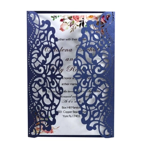 Detailed laser-cut dark blue pearlescent wedding invitation with floral insert card